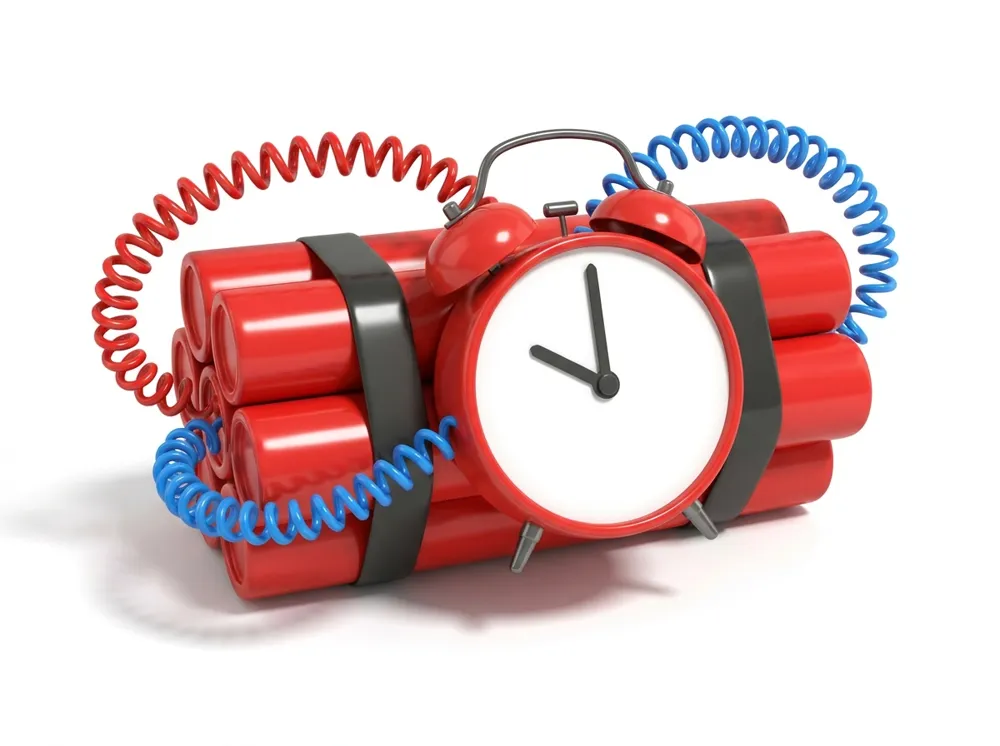 A clock strapped to a bundle of dynamite